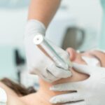 Close-up of a cosmetic treatment being performed in a clinical environment.